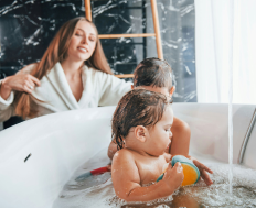 The child is enjoying hot water while being supervised by a parent