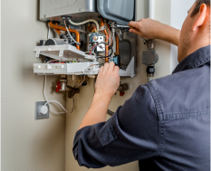 An engineer is repairing a boiler