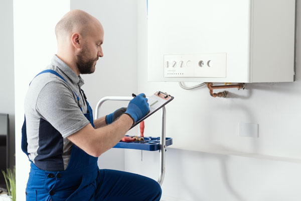 Gas engineer maintaining a checklist during inspection